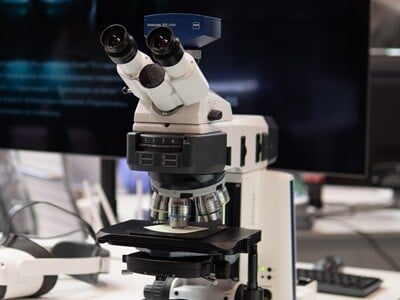 An image of a microscope on a laboratory bench.